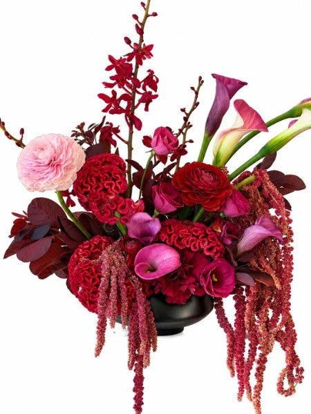 Crimson Romance Floral Arrangement with red ranunculus, calla lilies, orchids, and cascading amaranthus