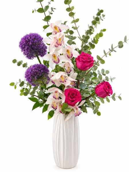 Orchid and rose luxury bouquet in a white ribbed vase