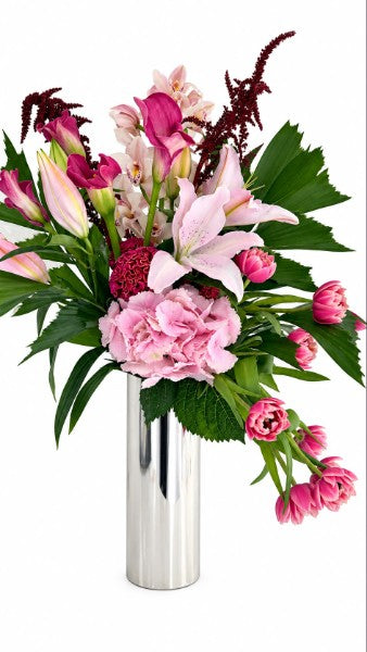 Pink Elegance Bouquet with hydrangeas, lilies, tulips, orchids, and burgundy amaranthus in a silver cylinder vase