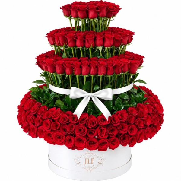 Tiered red rose arrangement in a white JLF signature hat box with white ribbon bow