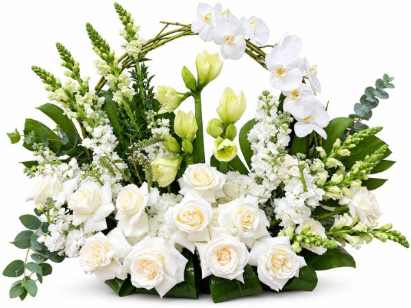 Elegant white floral basket arrangement with roses, orchids, and greenery
