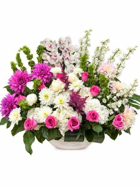 Garden Bliss Floral Arrangement with pink roses, purple dahlias, white orchids and chrysanthemums in a white ceramic bowl